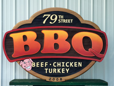 Image shows sandblasted Cypress wall sign for 79th Street BBQ in Chicago. Made in our Elkhorn Wisconsin studio, Signs Madison